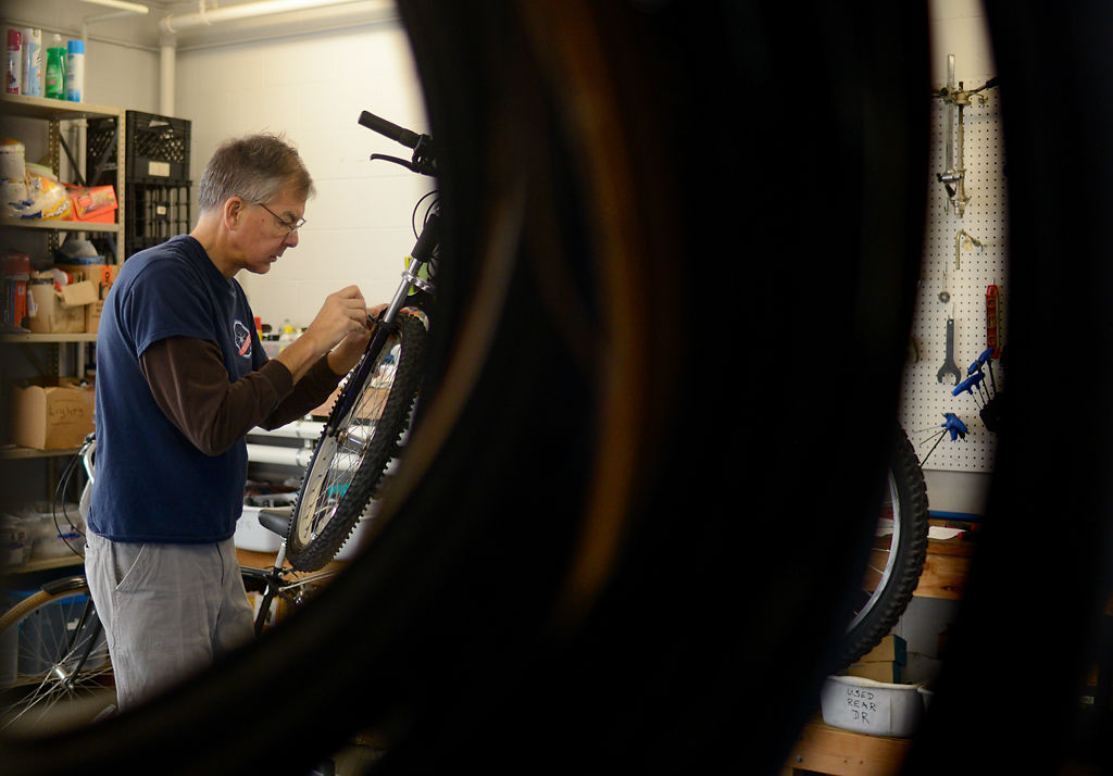 Tom Grothe repairs a bicycle